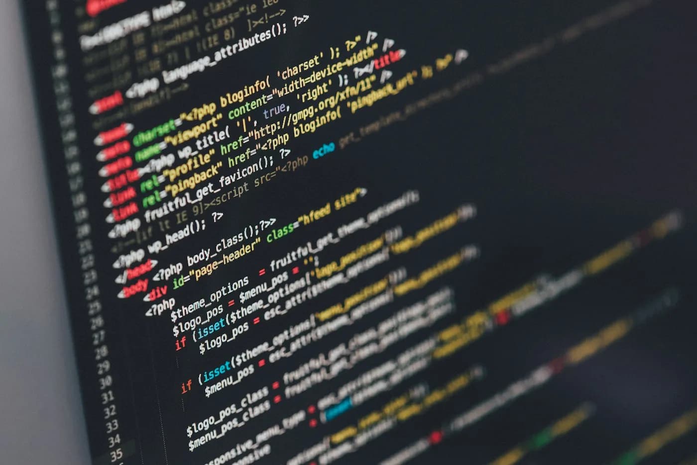 A close view of multicoloured source code on a dark screen