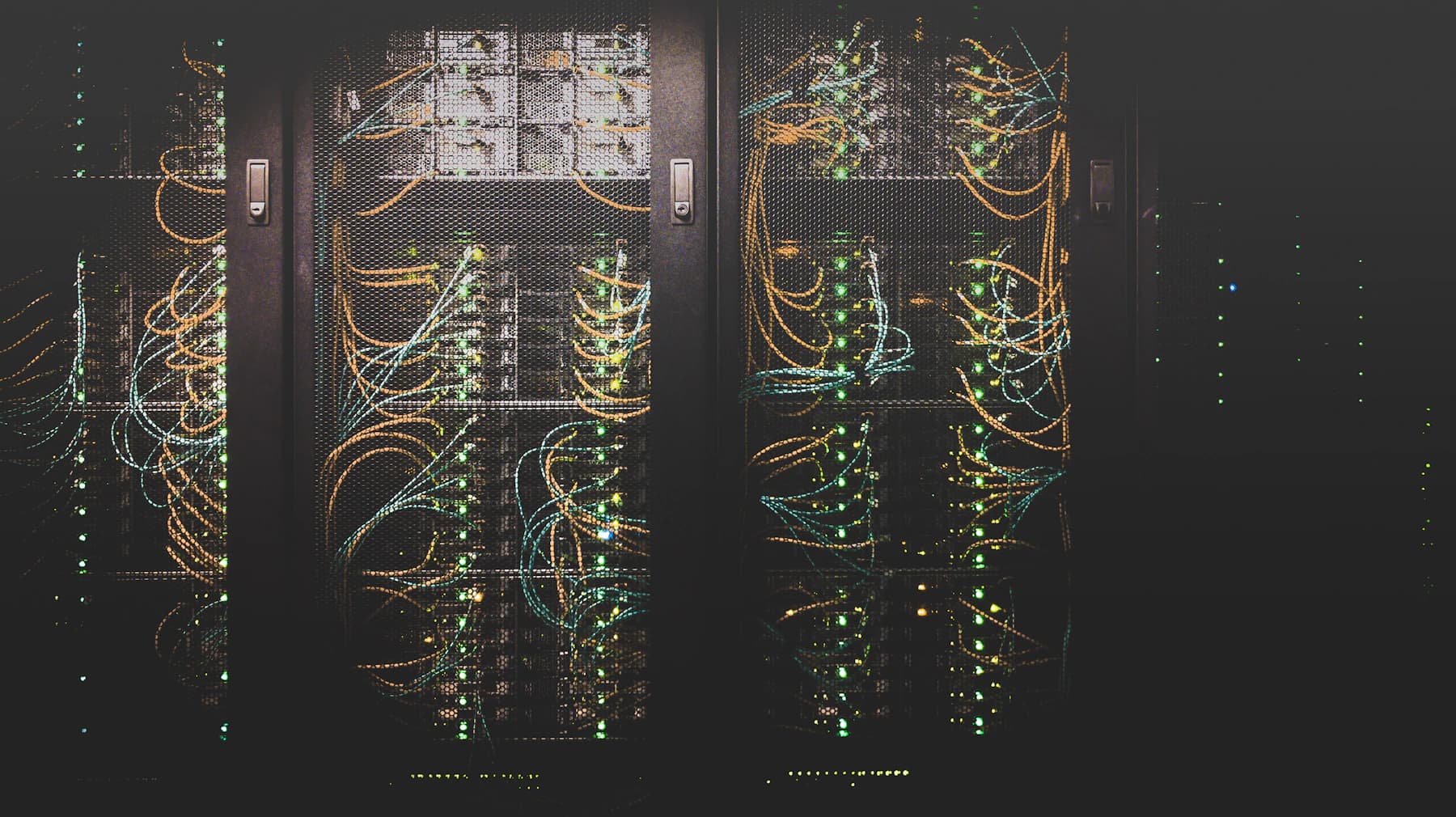 Server cabinets with network cables and illuminated status indicators