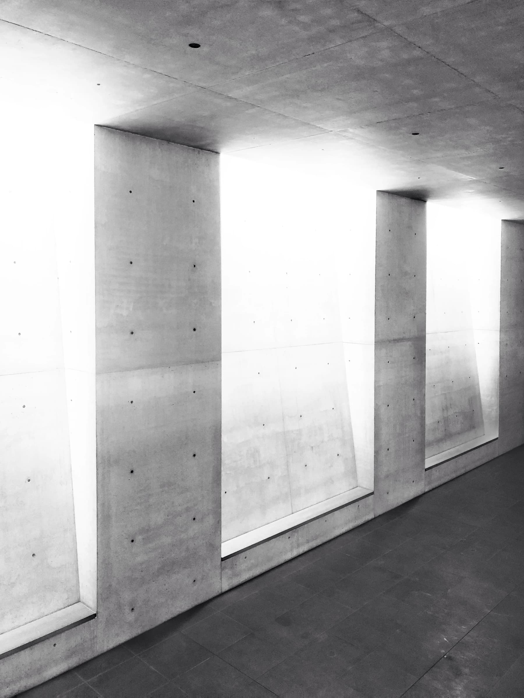 Daylight tracing precise geometric shapes across minimalist concrete architecture